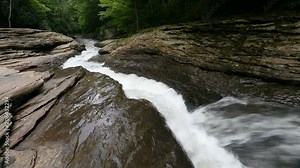 Meadow Run Creek races down a chute carved into the rock that many enjoy using as a natural water slide in Pennsylvania's Ohiopyle State Park. Stock Video