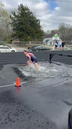 Runners Take a Splash During Steeplechase Water Jump