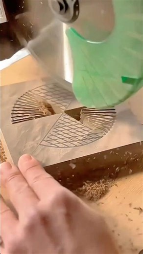 Automatic wood carving machine cutting detailed radial patterns into a wood block