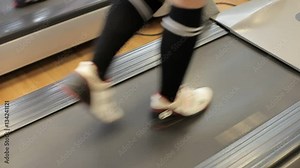 Running on a Treadmill. Girls in the gym go on treadmill. Two sports girls on treadmill. Legs. Close up. Running. The girl trains in the gym Stock Video