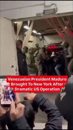 Venezuelan President Maduro Brought To New York After Dramatic US Operation 𝐍𝐞𝐰 𝐘𝐨𝐫𝐤, 𝐉𝐚𝐧 𝟒 (𝐖𝐄 𝐓𝐇𝐄 𝐍𝐀𝐆𝐀𝐒): Former Venezuelan President Nicolas Maduro was handcuffed and shackled as he arrived on American soil at Stewart Airport in Orange County, New York, following an extraordinary US military operation ordered by President Donald Trump. Maduro was flown by helicopter to Manhattan’s West Side, where Venezuelan Americans gathered as he and his wife, Cilia Flores, were transp