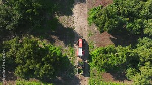 Tractor transporting pallets of Avocado across an Avocado tree plantation