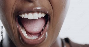 Shouting, mouth and closeup of woman in a studio with teeth for attention, emotion or alarm. Screaming, voice and zoom of African female model with yelling or loud gesture by white background.