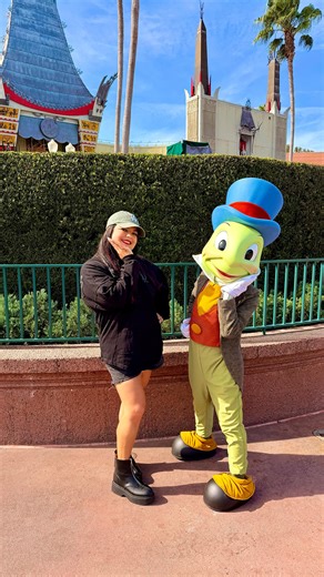 Corina Andino on Instagram: "The cutest little character Jiminy Cricket was out today! 💚 Growing up I didn’t have the opportunity to go to the parks so now I’m doing it all as an adult and OMG I’m loving every minute of it. Little me would be so happy! I’m so thrilled you’re here and on this adventure with me. . . . #disneyparks #waltdisneyworld #hollywoodstudios #jiminycricket #disneycharacter"
