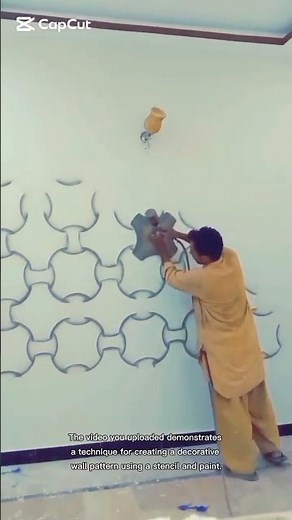 creating a decorative wall pattern using a stencil and paint.