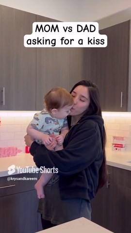 Mom and dad compete for a kiss from their favorite baby