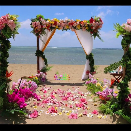 Tropical themed archway with Maile leis and floral tikis