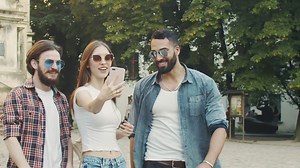 Friends say hello on video call while walking outdoors - Free Stock Video