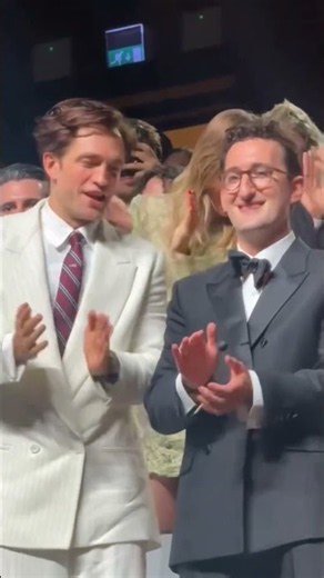 Robert Pattinson gives Suki Waterhouse a kiss as 'Primetime' receives a 7-minute standing ovation