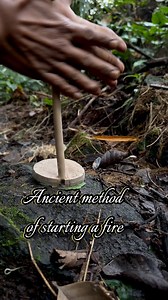 Hand drill with a fire board, a disc-shaped piece of wood #handdrill #primitivefirelighting #firemakingskills #bushcraft #frictionfire #outdoors #survival #selfsufficiency | dalemgumino