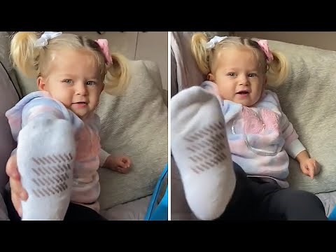 Adorable toddler asks mom for foot massage