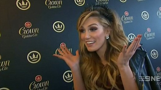 Delta Goodrem poses topless in a pool for the cover of Maxim magazine