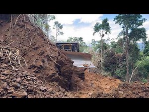 Clearing a Forest Path Using a CAT D6R XL Bulldozer in Difficult Terrain Prone to Landslides