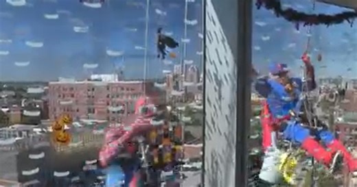 Superhero window washers greet children at Johns Hopkins Hospital