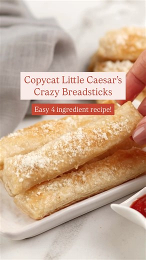 Copycat Little Caesar's Crazy Breadsticks - make these fluffy, buttery, garlicky bread sticks with just 4 ingredients! They're yummy as a snack or appetizer or to serve on spaghetti night! Ingredients: 1 can refrigerated pizza crust 1/2 teaspoon garlic salt 3 Tablespoons melted butter 1/4 cup grated parmesan cheese #breadsticks #carbsarelife | The Soccer Mom Blog - Positive Inspiration for Moms