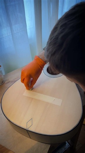 The first coat of shellac on a handmade guitar