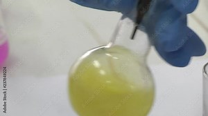 Lab worker analyzing meat sample magnifying glass. Laboratory studies of meat and meat products. Checking meat for compliance with sanitary requirements.