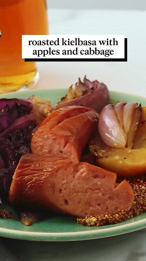 For a real taste of fall, turn to this easy sheet-pan dinner with kielbasa. It's a colorful meal that pairs the smoked pork sausage with wedges of red cabbage, sliced red onions, and halves of Gala apple. Get the recipe: https://bit.ly/3sVIF2r | Martha Stewart
