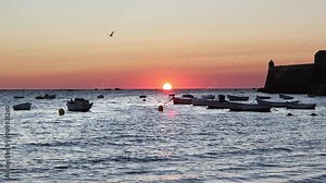 A spectacular sunset at Playa de la Caleta, Cádiz, Spain. One of the best-known urban beaches in Spain.