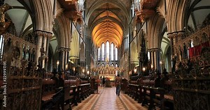 Worcester Cathedral of Christ inside woman walks to altar. Historical medieval city as military stronghold, religious center, university and market. Cathedral Church of Christ or Priory 10th century
