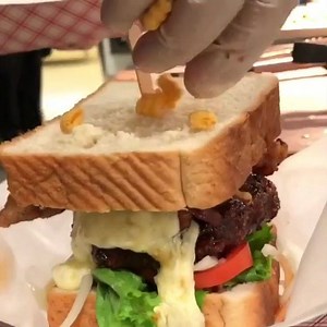 7.2K views · 104 reactions | BRAND NEW!! The Cap’N Crunch Fried Chicken Burger Submerged in Sriracha honey glaze and served with Lettuce, Tomato, Pickled Onions, five-spice thick sliced bacon with a blanket of muenster cheese finished on two slices of mom’s fresh white bread. YES the BREADING is CAP’N CRUNCH CEREAL!! Come experience what left the Food Network speechless. | 1950 Originals | Facebook