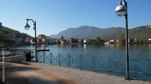 Porto Ceresio bay area. Pier on lake walk