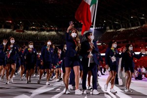 Two golfers carry country's flags during Olympic Opening Ceremony in Tokyo