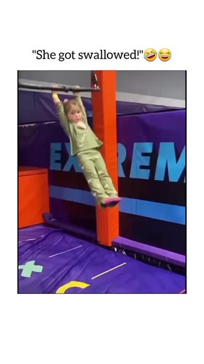 world_vibess1 on Instagram: "Follow mee friends?.......The video opens at an indoor trampoline or "extreme" sports park. A young girl, dressed in a light green matching pajama-style outfit, is standing on an elevated orange padded block. An adult woman is standing behind her, helping her get a firm grip on a black overhead trapeze-style bar. ​The "Extreme" Drop ​As the music plays, the girl gathers her courage and swings out from the platform. ​The Swing: She holds on tight as she glides through