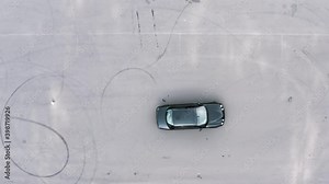 practical driving test. student on a black car bypasses obstacles. slalom by car between tires. aerial view. driving training area, driving course. Driving lessons training. top shot