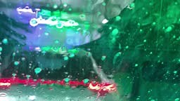 Close-up view from inside a car at a conveyor tunnel car wash....