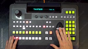 Broadcast stream from video switcher console mixer with mens hands