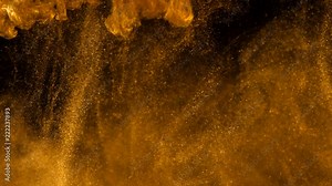 Golden ink in water shooting with high speed camera. Сopper drops of paint dropped, reacting, creating abstract cloud formations metamorphosis on black. Art backgrounds.