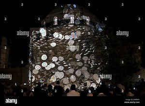 People watching a video projection depicting Israeli coins of 10 Agorot pouring over the reconstructed Hurva synagogue also known as Hurvat Rabbi Yehudah he-Hasid during the Jewish holiday of Hanukkah, the festival of lights, at the Jewish Quarter in Old city Jerusalem Israel Stock Photo - Alamy