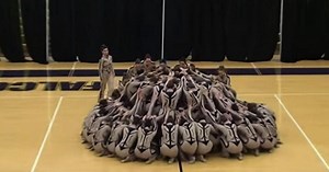 Large Group Of High Schoolers Form Circle–Viewers Focus On Choreography As Dancers' Legs Seperate