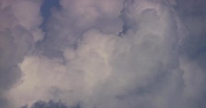 Download Time lapse of white giant cumulus clouds moving fast and disappearing on blue sky in 4K for free