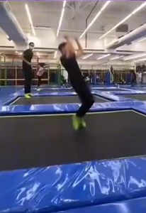 Kid runs onto trampoline, trips and gets hit