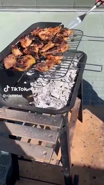 Grilling Chicken and Vegetables on a Rooftop Barbecue