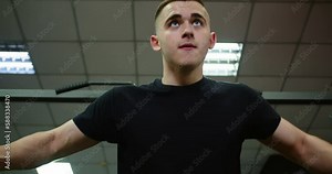 A man performing a cable cross exercise in a gym. This video shows the individual using the cable machine to perform arm adduction exercises that target the chest muscles. It's a great addition to any