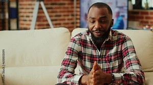 Remote professional holding q a session with webinar participants via video conference meeting in cozy apartment. Online video call host engaging in online discussions with trainees