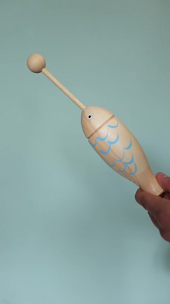 The Nami wooden fish tone block boasts a sturdy construction from solid wood with a vibrant painted design. This delightful percussion instrument is not only favoured among professionals but also serves as an engaging toy for children, provided they have supervision. We recommend its use for kids aged three and above. Complete with a durable solid wood beater stick, striking the fish produces a cheerful, resonant clack. #fish #toneblock #clacker