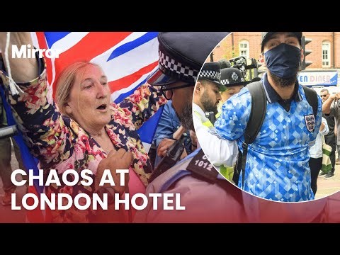 Protesters and police CLASH outside London hotel housing asylum seekers