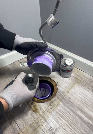 Professional Plumber Fixes a Leaking Toilet