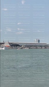 Panoramic view of Amsterdam Central Station with its curved roof and the Amstel River timelapse