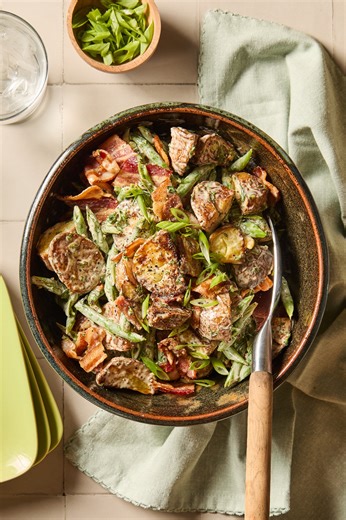 PRINT the recipe: https://www.wyseguide.com/potato-green-bean-salad/ Potato and green bean salad gets a savory upgrade with crispy bacon, golden roasted potatoes, and a creamy dressing perfect for summer cookouts. INGREDIENTS - 2 lb gold potatoes, cut into 1/2-inch cubes - 2 lb trimmed green beans, cut into thirds - 2 tbsp olive oil, separated - kosher salt - freshly ground black pepper - 6 scallions, chopped - 12 oz bacon, cooked and chopped For the dressing: - 3/4 cup mayonnaise - 1 tbsp lemon