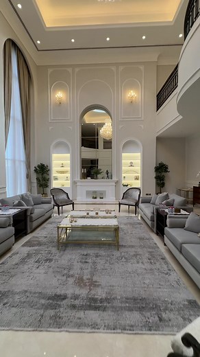 Explore the perfect blend of classic aesthetics with the sleek, minimalistic appeal of contemporary trends in our latest living room project! ✨ 🛋️ Soft creams, warm beiges, and subtle grays take center stage, creating a timeless, elegant ambiance perfect for a luxury villa in Al Khawaneej, Dubai. 👉 From classic wall molding to window arches, ceiling dome cornice, and a stunning feature wall with a fireplace mantel, mirror, and display shelves - it's a harmonious symphony of elegance and comfor