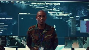 Major general updating and maintain the command center databases with current operational data, monitoring surveillance radar footage to ensure national safety. Control room. Camera B.