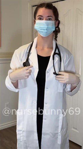 Showing of my outfit with a black dress, white lab coat, white latex gloves, blue ear loop mask, and black Littmann stethoscope. Do you like this or the vintage nurse better?