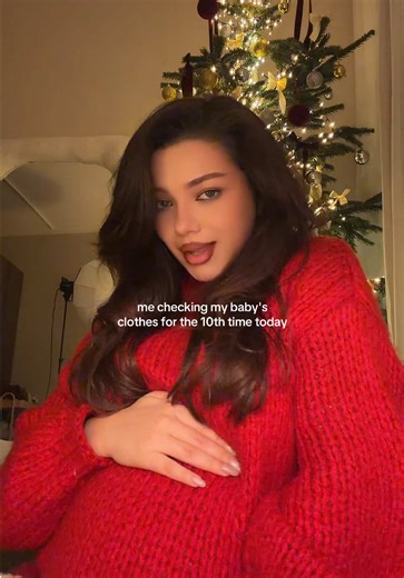 Mom-To-Be's Excitement: Checking Baby's Clothes