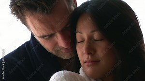 Young couple in bed kissing