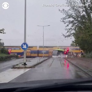 19K views · 315 reactions | A bus idling at a railroad crossing in the Netherlands was split in half after it was crushed by a train. Nobody was injured during the incident. | CBS News | Facebook